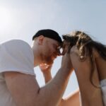 man kissing womans forehead