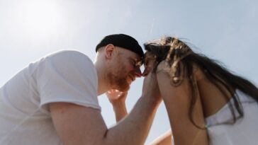 man kissing womans forehead