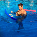 Tommy Schlesser and his cute daughter swimming in a pool