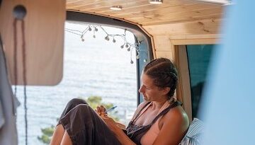 A lady comfortably sitting in RV recreational vehicle