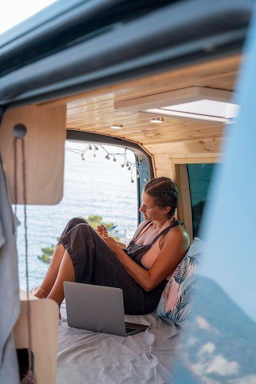 A lady comfortably sitting in RV recreational vehicle