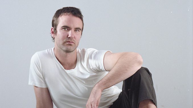 Scott Hardware wearing a white shirt and sitting down